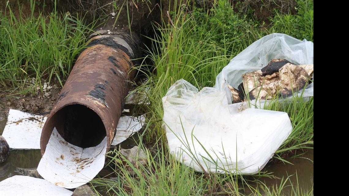 
Absorbent pads try to catch oil around a drainage pipe near a crude oil pumping station in eastern Madison County.
