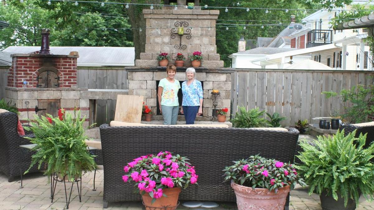 Window boxes and pots overflowing with colorful brooms, plus a wisteria covered entrance invites visitors to enter this spacious enclosed patio in this stop on the Highland Garden Tour. Pictured are Highland Garden Club members Nancy Hediger and Joyce Zerban.