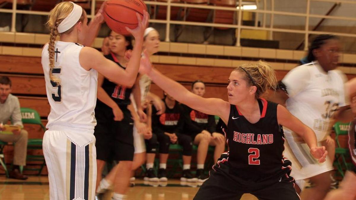 Highland senior guard Rece Portell plays tight defense on Althoff junior Gabby Siekmann during the Lady Bulldogs’ 52-35 victory over the Crusaders Saturday night during the Salem Lady Wildcats Thanksgiving Tournament.