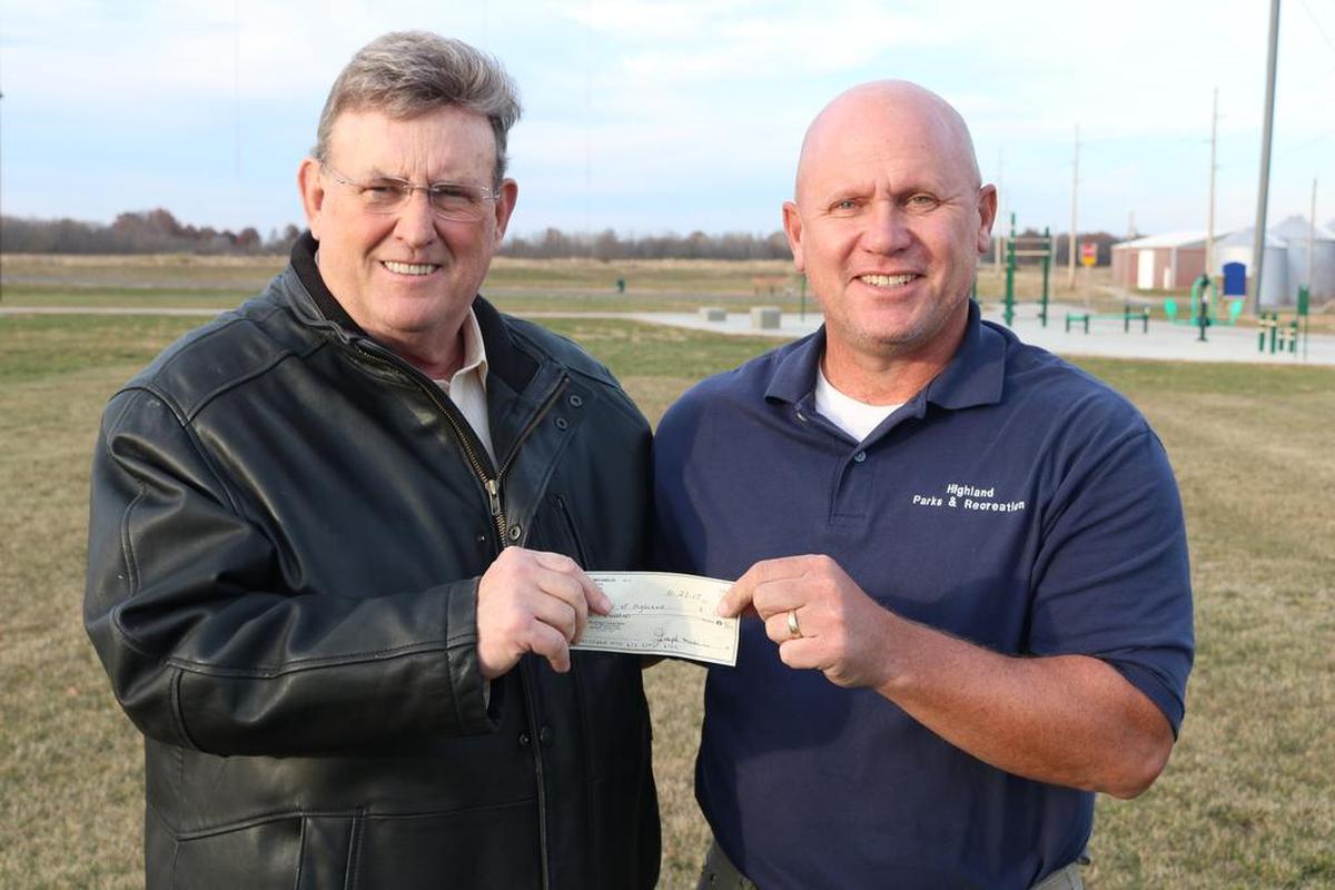 Mayor Joe Michaelis presents Director of Parks and Recreation Mark Rosen with a personal check for $1,000, which is the first pledge towards the all-abilities playground to be built at Dennis H. Rinderer Park on Veterans Honor Parkway. The Highland City Council gave their blessing to Rosen to pursue the playground during its meeting on Nov. 20. While Michaelis has made his own personal pledge, the city is no official structure yet to receive any donations at the moment. City officials will announce when the city starts its fundraising for the play area.