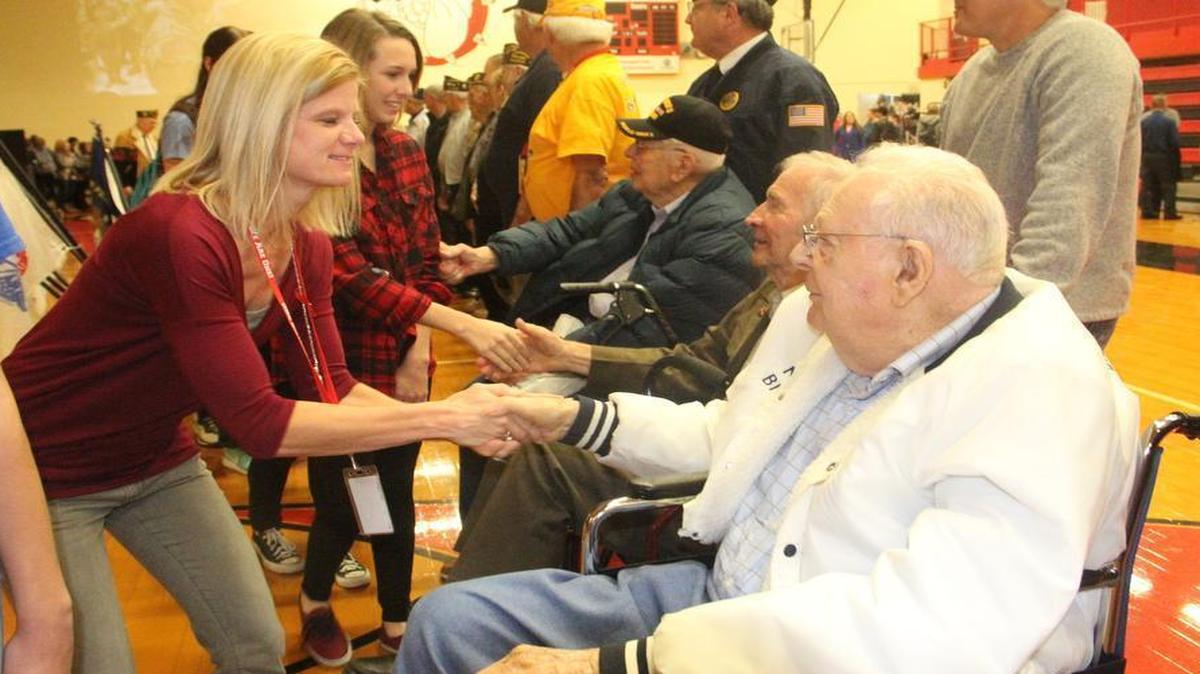 Highland High School guidance counselor shakes Laverne Strotheide’s hand after Tuesday’s Veterans’ Day Assembly held at the school.