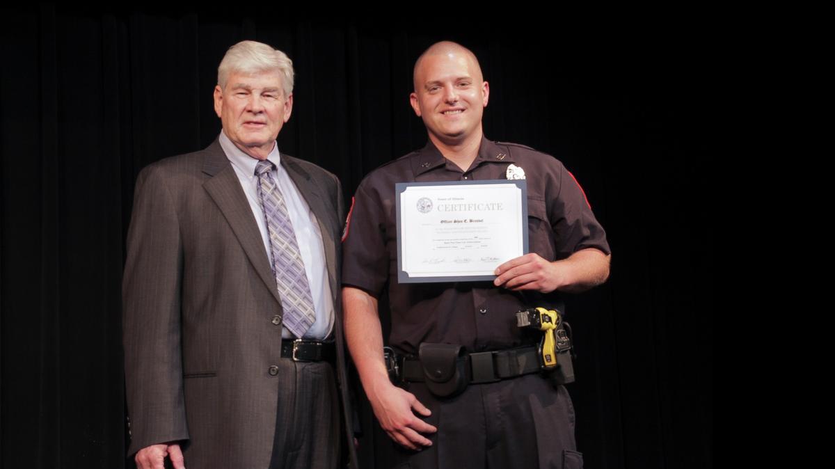 
Grantfork Police Officer Shea E. Brendel, right, receives his graduation certificate from Southern Illinois Law Enforcement Commission Director Bill Fitzgerald during the Southwestern Illinois College Part-Time Police Academy Session 24 Graduation held recently at the college. The SWIC Police Academy is an intensive academic and physical training program designed to prepare recruits to enter a career in law enforcement. The part-time academy classes meet once every three weeks for nine months. It is one of only six police academies in Illinois.
