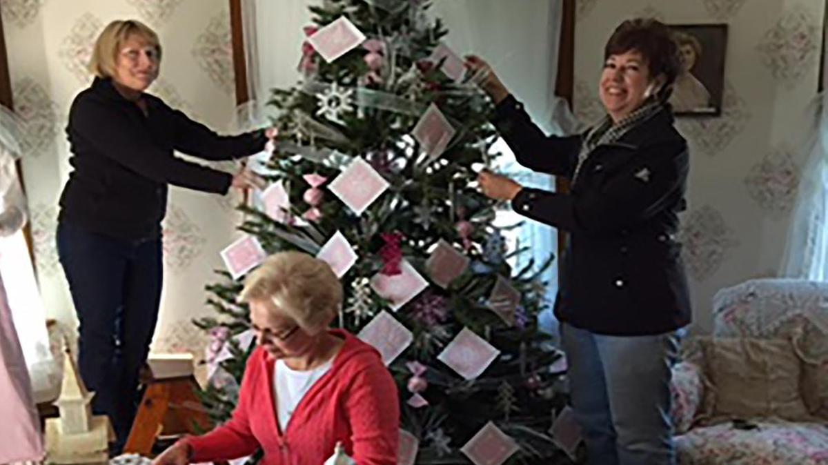 Pat White, Linda Abendroth and Laurie Kurwicki of the St. Paul Mega Flea Market committee decorate Miss Alice’s room for her trip to France at the Latzer Homestead.