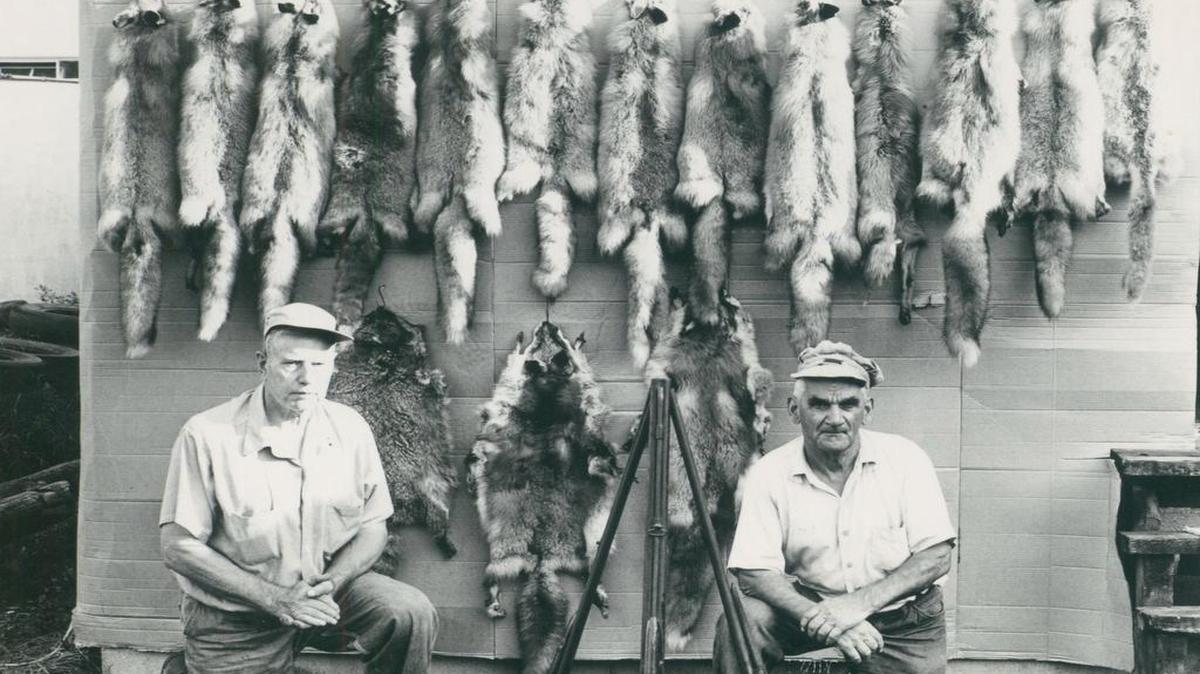 Displaying trophies from their favorite sport are Robert Mannhard, on left, and Leo Wirz. Photo from the Roland Harris collection.