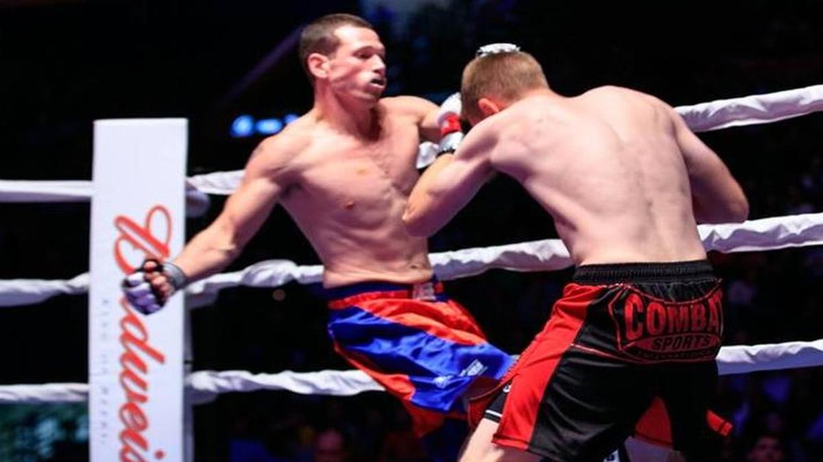 Highland police officer Nathan Biggs, left, fights Scott Lilly, a paramedic from St. Louis, at the recent Guns ’N Hoses in St. Louis.