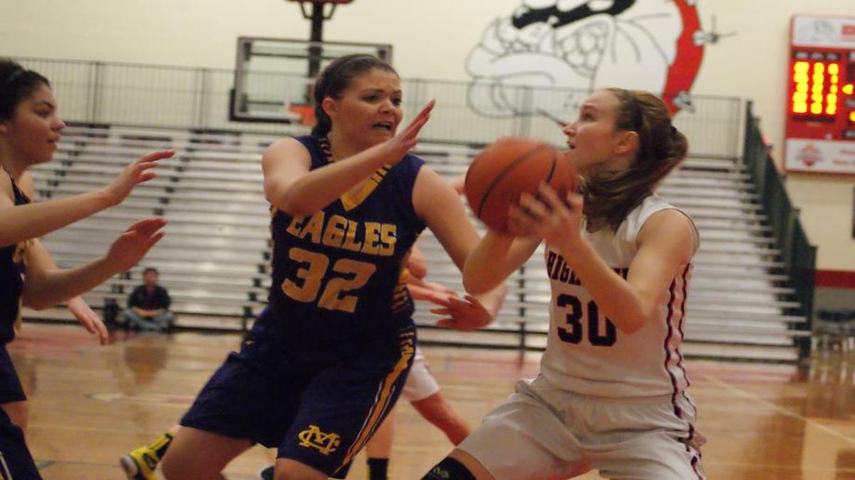 Highland senior Hayley Taylor looks for room to operate on the baseline against Civic Memorial junior Alaira Tyurs in the Lady Bulldogs’ 51-48 victory over the top-ranked Eagles Saturday morning in the opening game of the Highland Optimist Shootout.