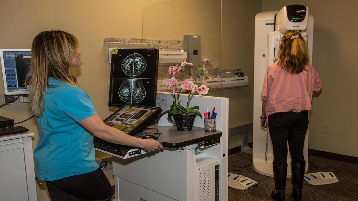 Lisa Kustermann, a mammogram tech at HSHS St. Joseph’s Hospital, shows a patient the newest 3D mammography service starting in early March at the hospital.