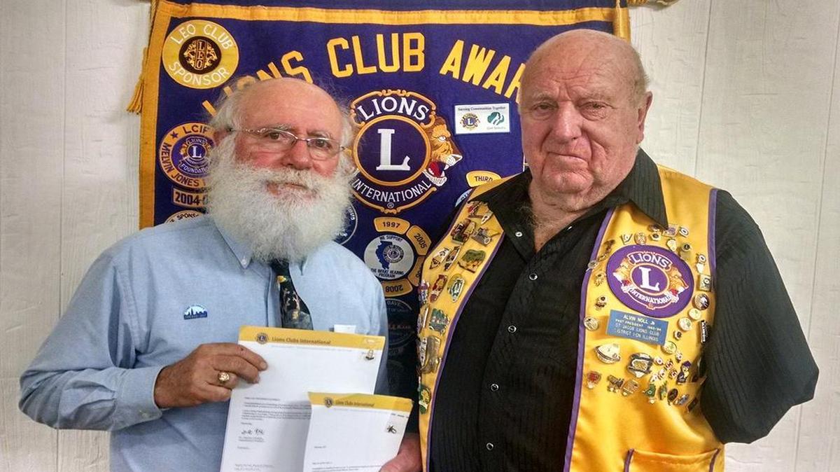 St. Jacob Lions Club members President Alvin “Red” Noll (right) and Lion Richard Schmidt were presented with certificates from Lions International recognizing 50 years of service to the St. Jacob Lions and the projects they support both local and international. The presentation was given by District 1-CN governor Elmer Ragland at the Governor’s Night Banquet at the St. Jacob Activity Center on Oct. 28.