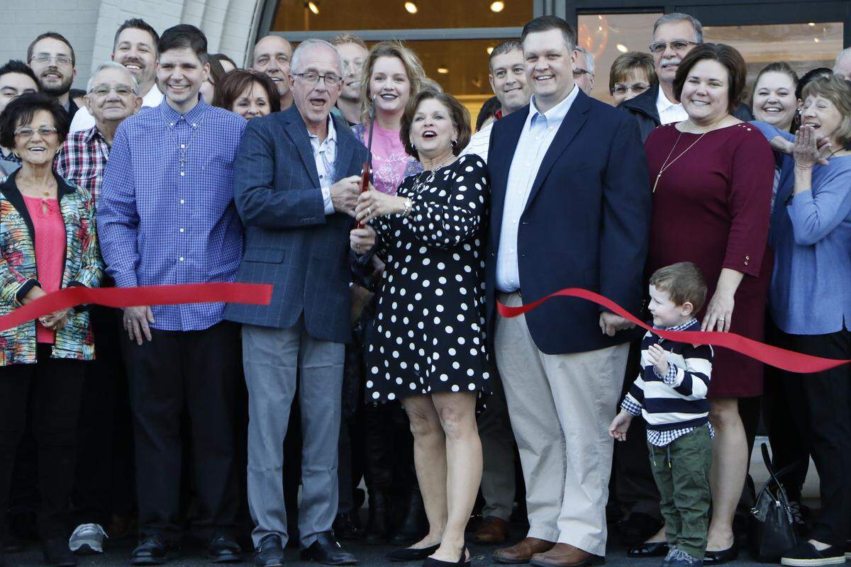 The Kloss family celebrates at the ribbon cutting of the newest Kloss Furniture store located in the heart of downtown Highland. The store, which was rehabbed after serving as a Schuette’s Market for 20 years, opened Nov. 2.