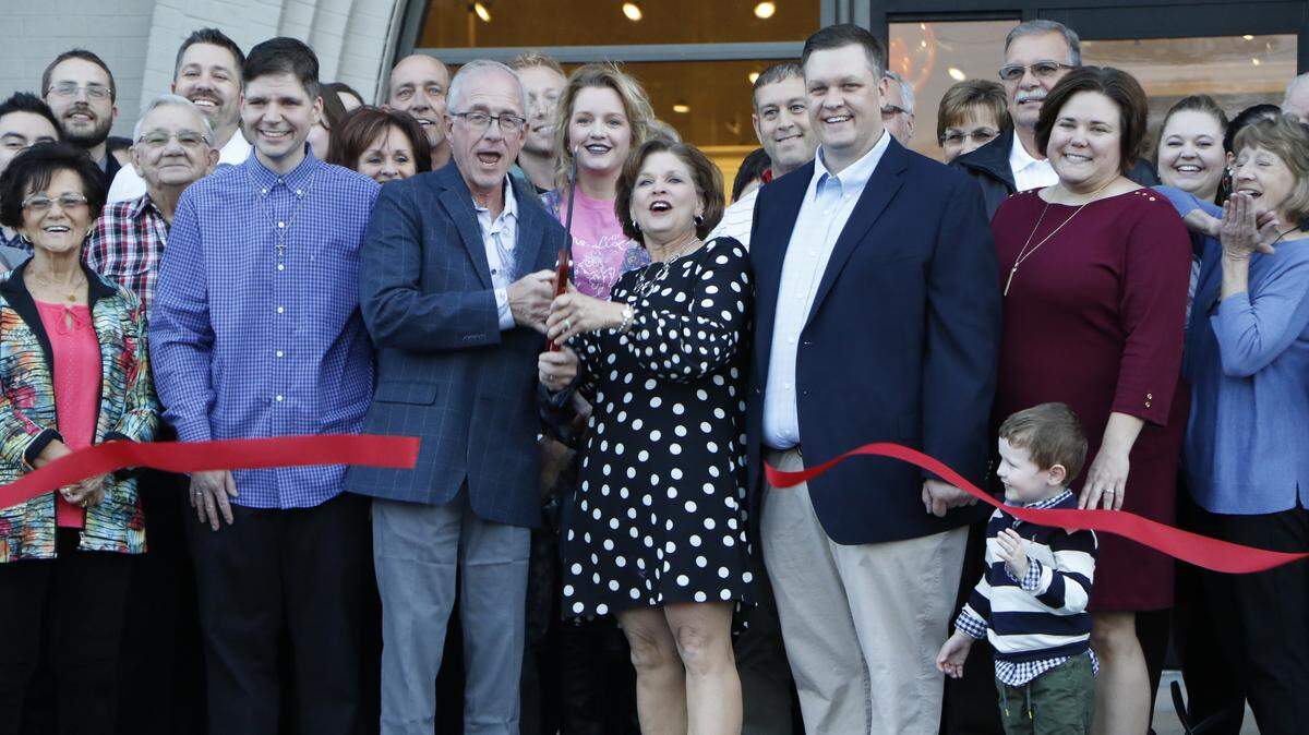 The Kloss family celebrates at the ribbon cutting of the newest Kloss Furniture store located in the heart of downtown Highland. The store, which was rehabbed after serving as a Schuette’s Market for 20 years, opened Nov. 2.