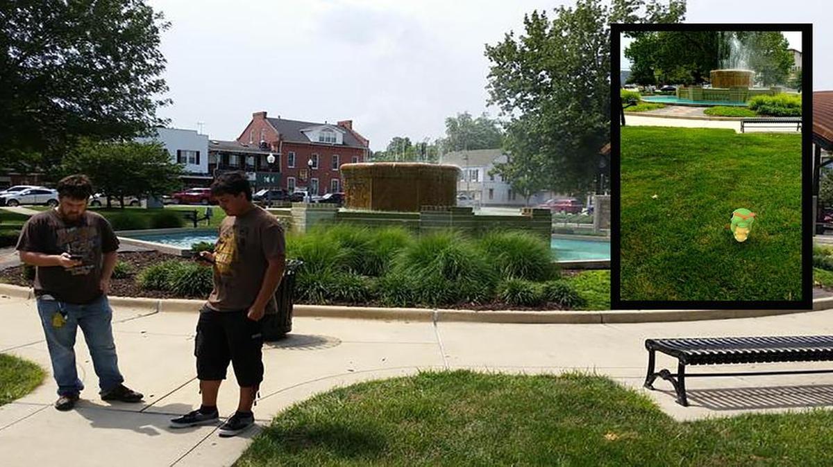 Pocahontas resident Austin May, 22 (left), and Greenville resident Chuck Thilman, 20 (right), were at the Square in Highland trying to catch Pokémon and defend their gym from being overtaken by another faction. Inset: Caterpie, a bug-type Pokémon, awaits capture near the fountain at the Square. The “Pokémon Go” app allows users to catch digital creatures in real-world settings.