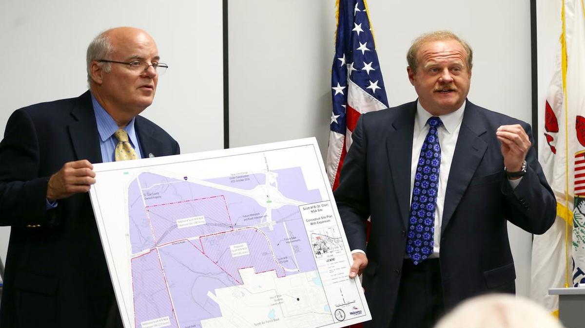 Madison County Board Chairman Alan Dustan assists St. Clair County Board Chairman Mark Kern in announcing Monday morning that St. Clair County is offering an additional 200 acres to the National Geospatial-Intelligence Agency in an effort to bring the agency to a county-owned site nextdoor to Scott Air Force Base. The county had already offered 182 acres to the NGA, which is planning to relocate by 2021.