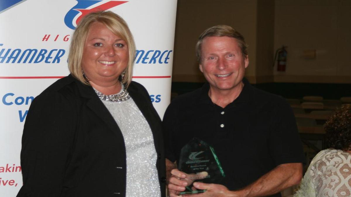 Highland Chamber of Commerce President Tricia Buehne (left) awards the Business Person of the Year award to Jim Gutzler (right).