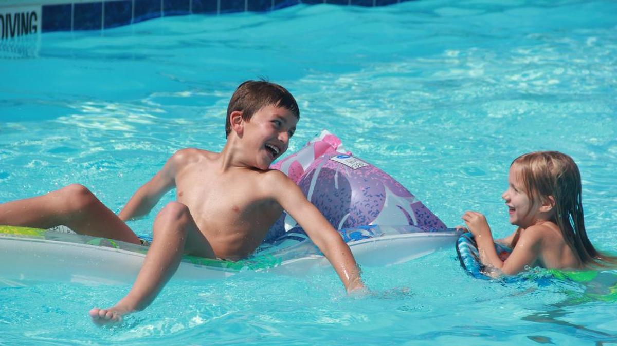 Brayden and Lyla Keller play Friday in the community pool at Hearthstone subdivision in north O’Fallon.