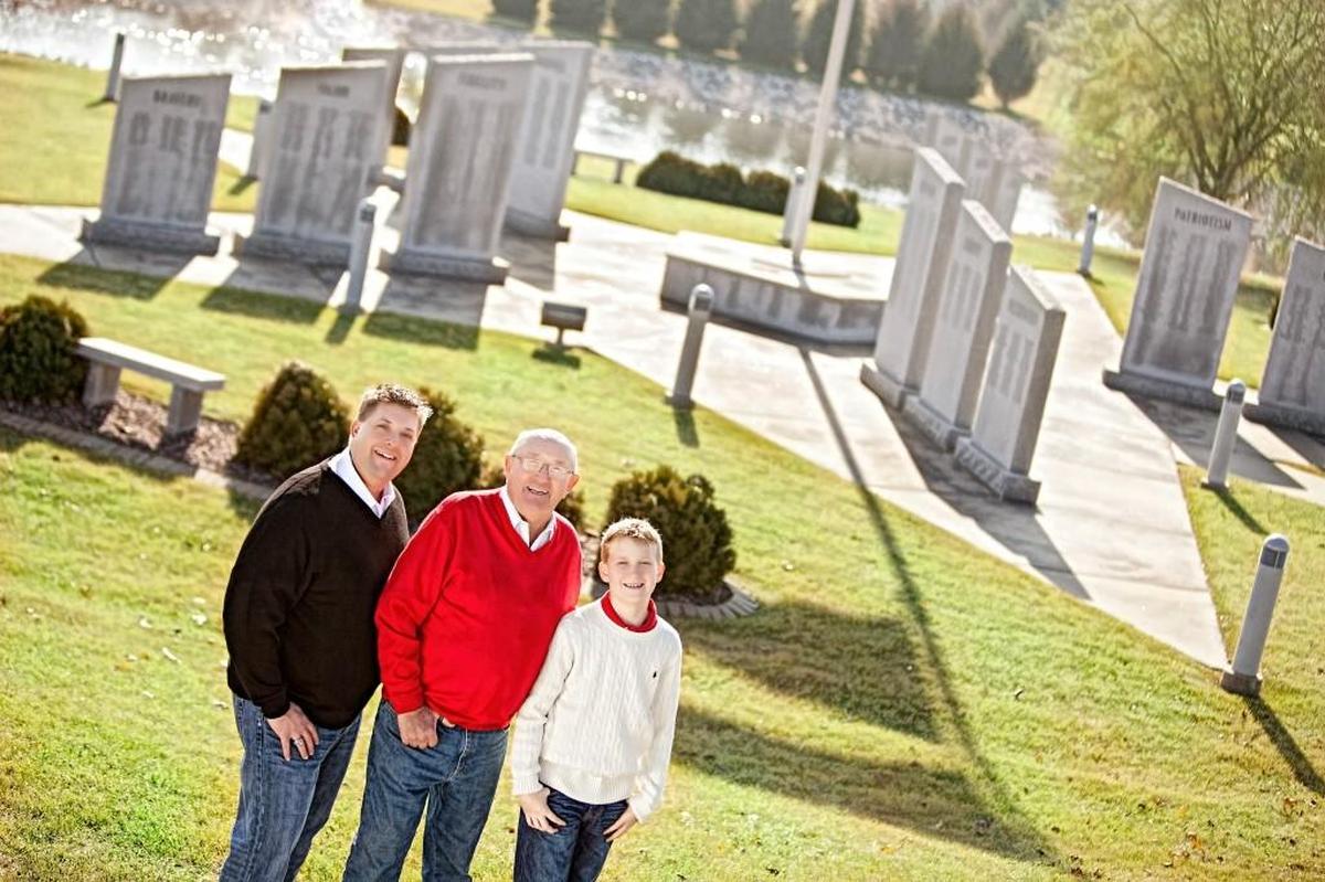 Jason Spengler, his son Logan and father Syd pose at the O’Fallon Veterans’ Monument prior to 2016. The family has been instrumental in creating and maintaining it.