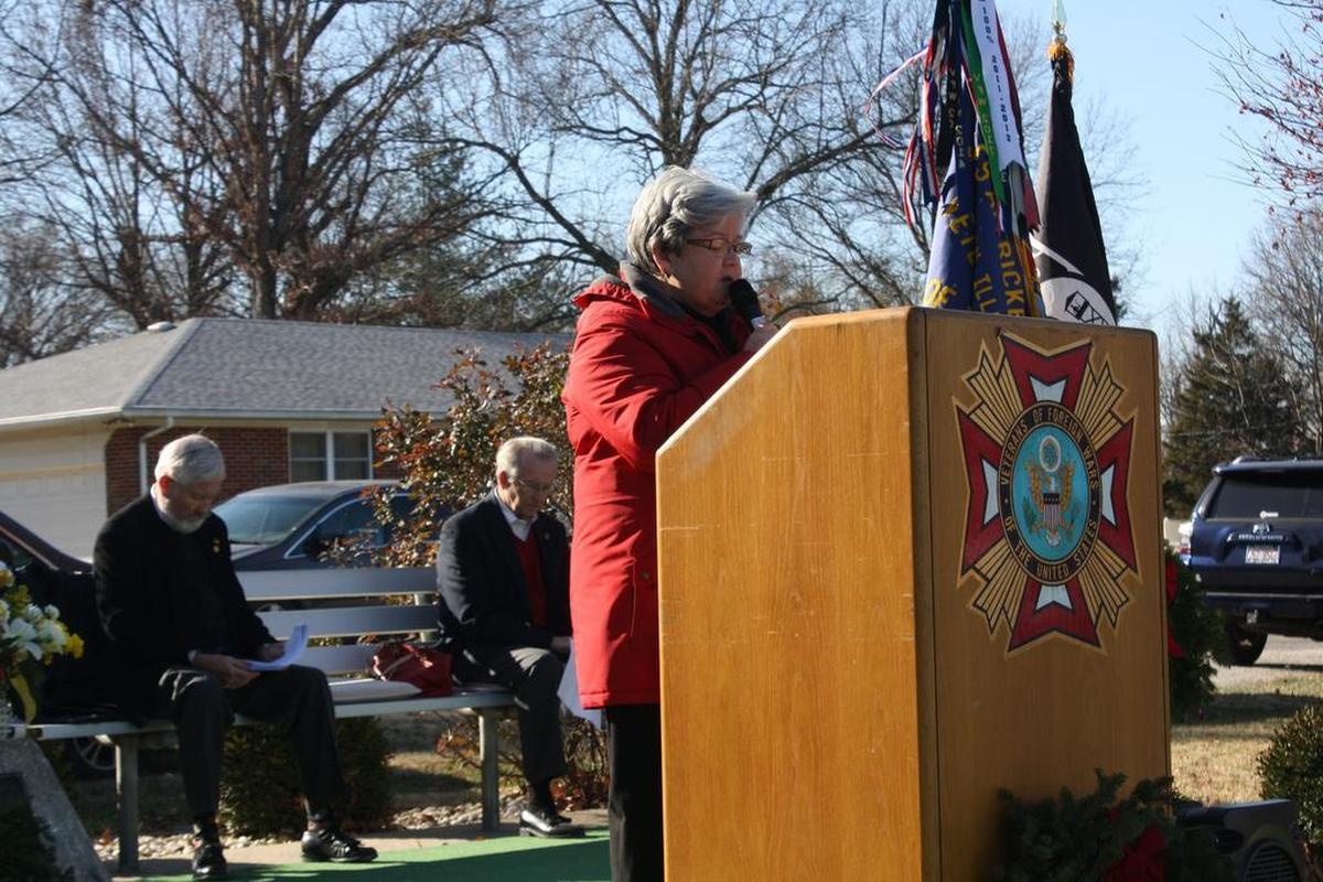 O’Fallon Noon Rotary Club member Mary Alice Koriath leads attendees in prayer during the Wreaths Across America ceremony Saturday, Dec. 16 at O’Fallon Cemetery sponsored by the O’Fallon Rotary Club, Veterans of Foreign Wars, O’Fallon Fraternal Order of Police, Bob Eckert, The Egg & I, Schildknecht Funeral Home and many more. Sitting left, is retired USAir Force Col. Phil Goodwin and O’Fallon Mayor Herb Roach.