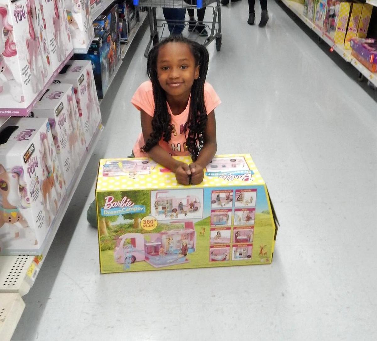 Jada, 7, with Barbie camper purchased during OPD’s Christmastime Cops and Kids event at Walmart.