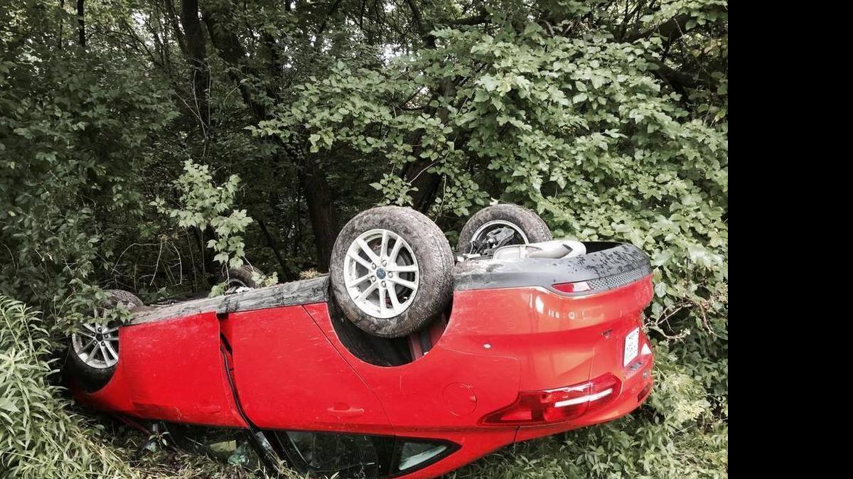 
A red Ford Focus with New Hampshire plates overturned on Hartman Lane Wednesday afternoon and traveled down a large embankment, coming to rest on its roof near the treeline.
