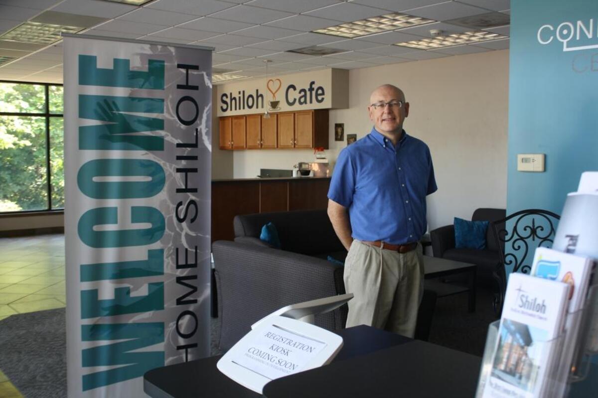 Shiloh United Methodist Church Pastor Ken Hutchens stands in front of the newly renovated gathering space and cafe area in the 2001 addition of the church at 210 S. Main St. in Shiloh.