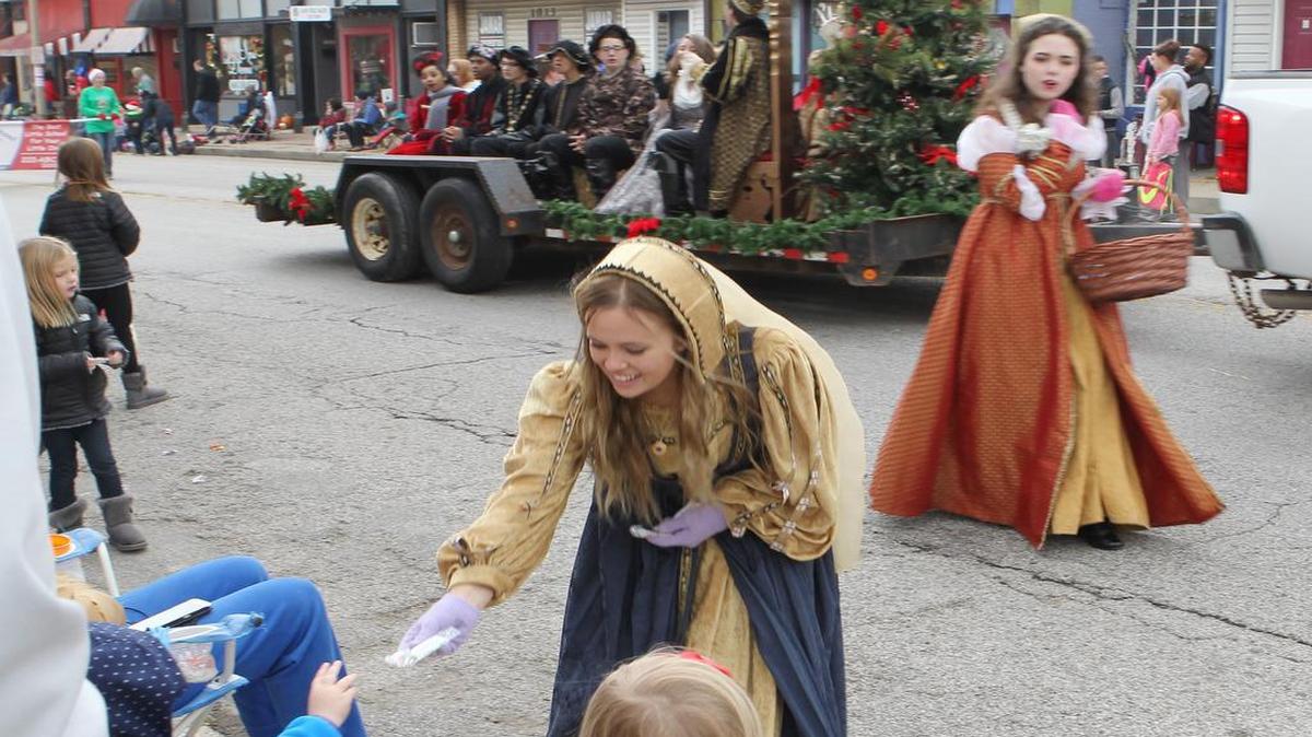 Members of the O'Fallon high school Madrigal singers hand out candy and sing for the crowd during the annual Santa parade. The group has a performances on the Milburn campus the first weekend in December.