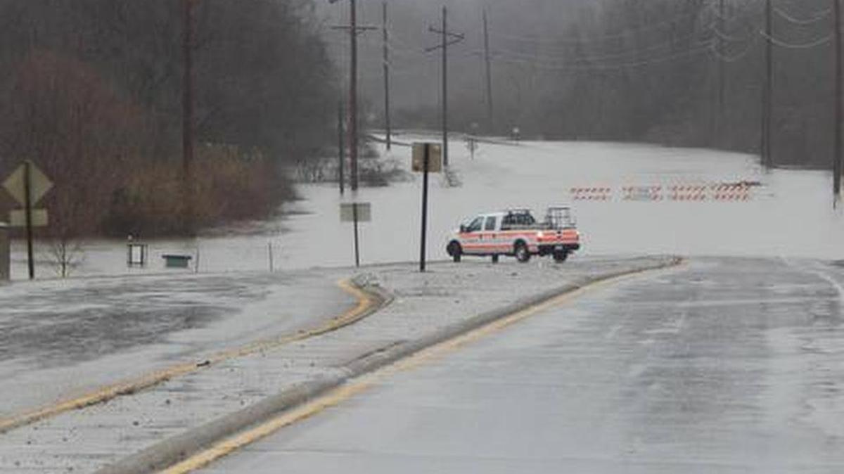 Illinois Department of Transportation worker John Crump sits at the edge of flooding from Silver Creek across U.S. 50 between O’Fallon and Lebanon. The road closed by 9 a.m. Monday.