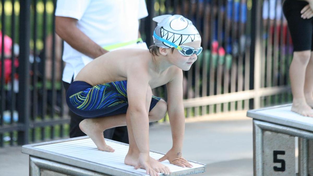Breakers swimmer Luke Peterson readies on the block for the start of the 25 free against Freeburg. Luke won the 6-under event and O’Fallon won the meet 387-136.