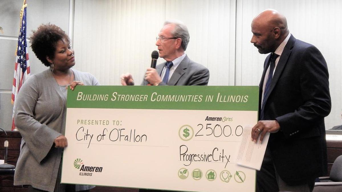 Paula Nixon and Ray Riddle, both of Ameren, present Mayor Herb Roach with a $,2500 grant.