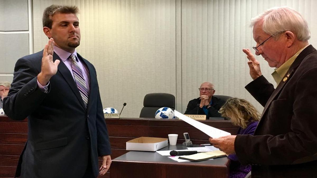 New O’Fallon alderman Chris Hursey is sworn in by City Clerk Philip Goodwin.