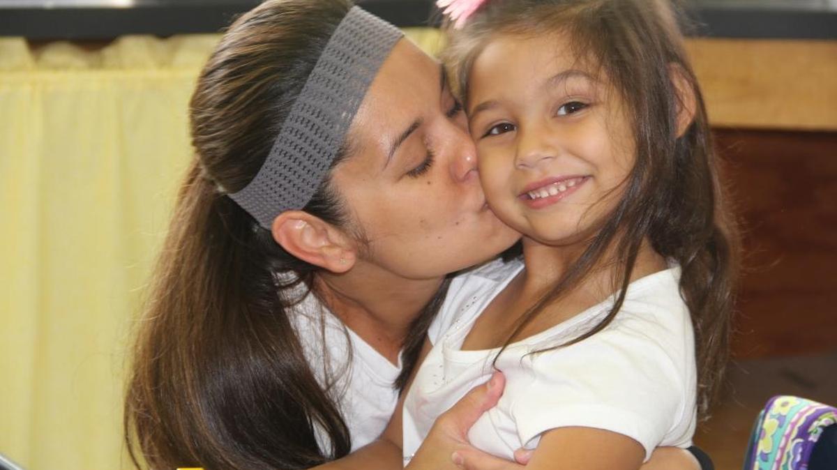 Michele Pratt gives her daughter, Kendyl, a hug and kiss on the first day of school recently. Kendyl started kindergarten at Kampmeyer School in O’Fallon this morning.