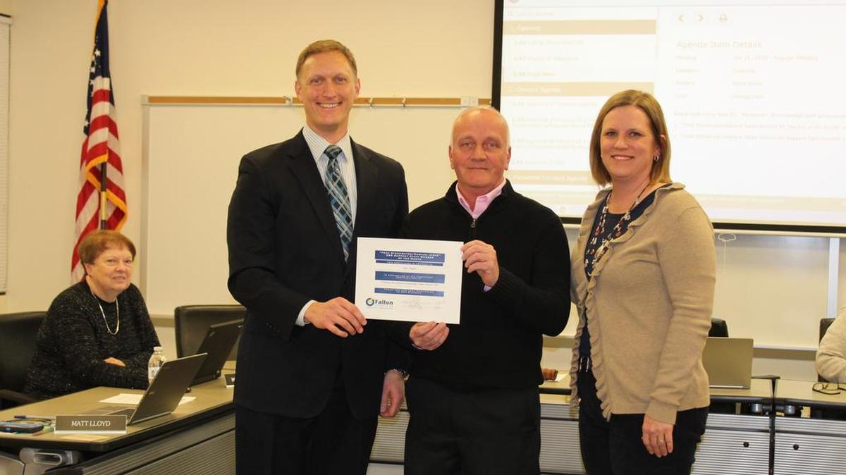 From left, John Wagnon, O’Fallon School District 90 Board of Education president; Eric Taylor, program aide at Carriel Junior High; and, Ellen Hayes, Carriel principal, honor the staffer of the month for January 2017 during the BOE monthly board meeting this month.