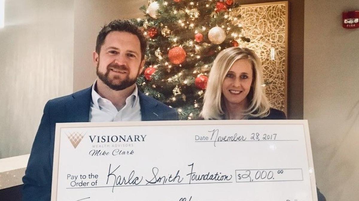 Mike Clark of Visionary Wealth Advisors in O’Fallon donates $2,000 to the Karla Smith Foundation, an organization founded to drive awareness to mental illness and substance use disorders.