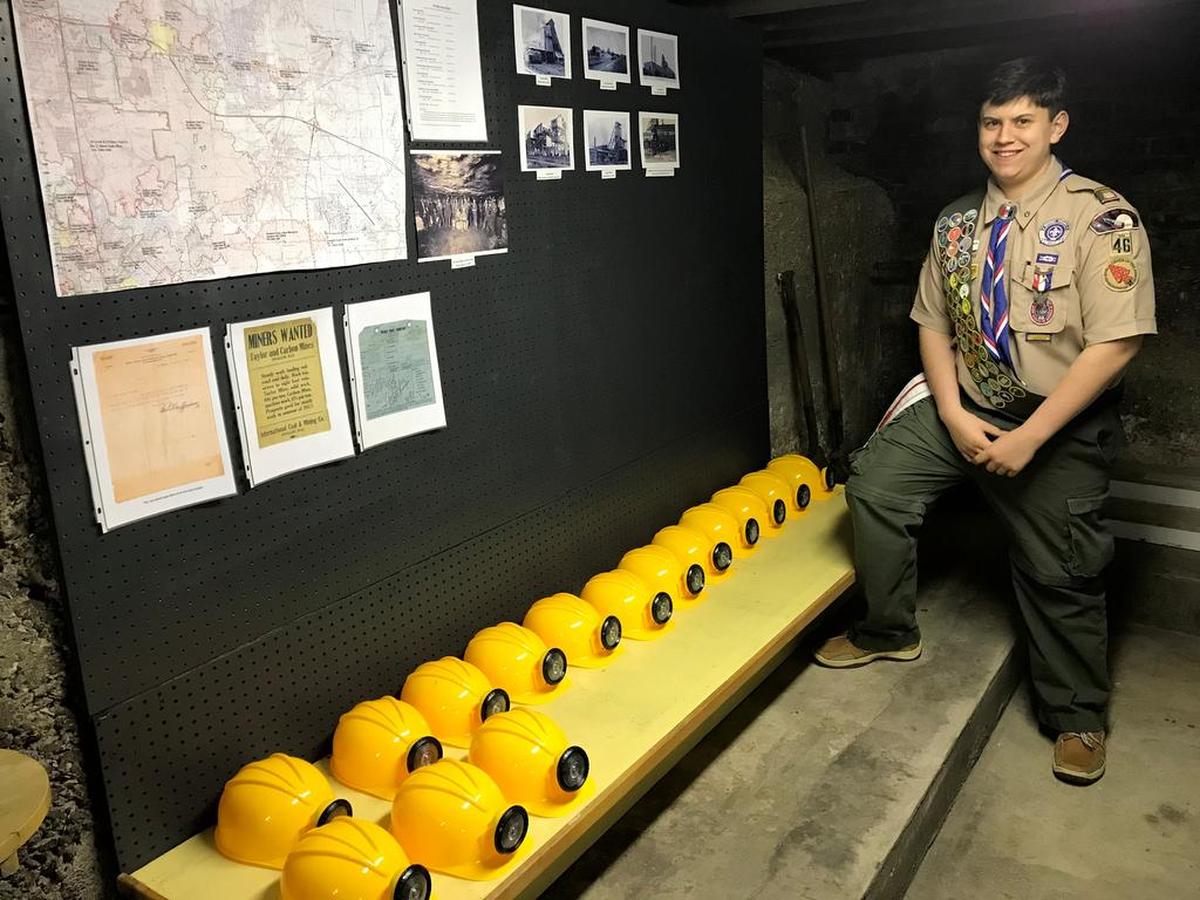 Tommy Fulford stands next to miner’s hats inside his recently finished O’Fallon History Museum Coal Mine Exhibit he worked on over the course of nearly two years for his Boy Scouts of America Eagle Scout Award, which he received Jan. 28, 2018.