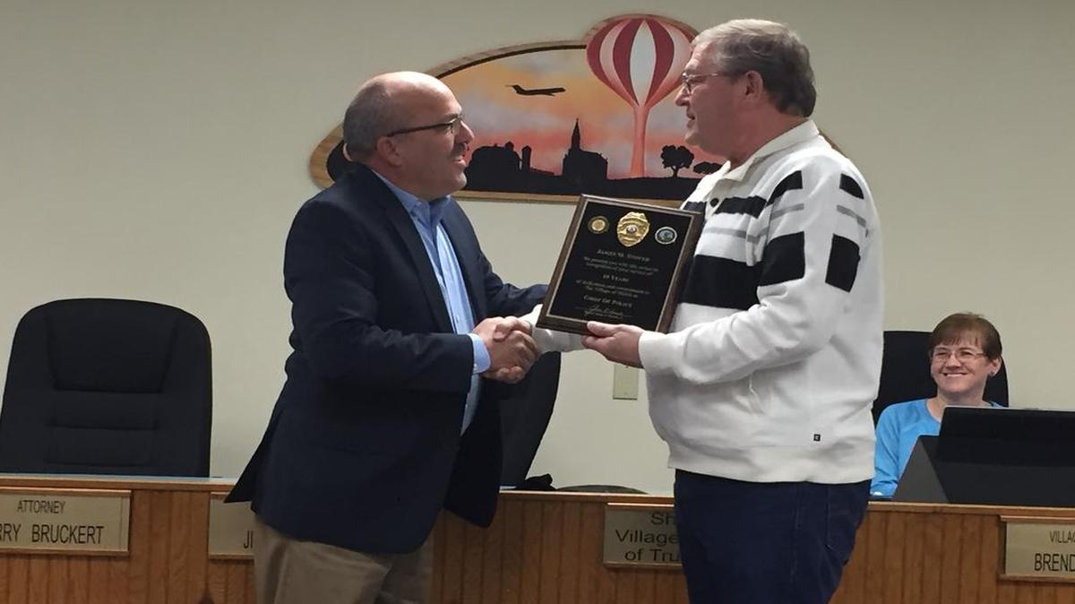 Left, Shiloh Mayor Jim Vernier presents recently retired police chief Jim Stover with an award for his 10 years of dedicated tenured service to the village. Brenda Kern, village clerk, smiles on while Stover receives his award during Tuesday, Jan. 3, 2017 meeting at village hall.