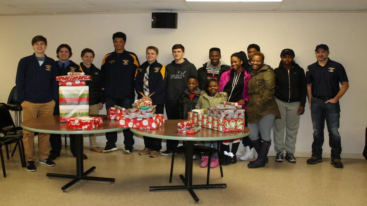 The O’Fallon Ice Hockey Club adopted a family from the O’Fallon Sgt. Charles E. Fricke Post 805 Veterans of Foreign Wars for the holidays for the first time. Left to right, Parker Johnson, Garrett Hagarty, Jack Gozard, Donavan Balisteri, Brandon Mayfield, Cody Wyatt, Chris (adopted child), Rodney (adopted child), Patrick Roy (head OHIC coach), Sharron (adopted child), De’ahnah (adopted child) and Shaniyah (oldest daughter).
