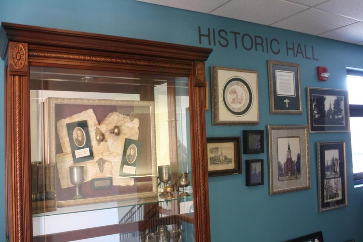The historic wall located between the 1875 church chapel and the 2001 addition highlights historical documents, photographs and artifacts of the church’s long 210-year history.