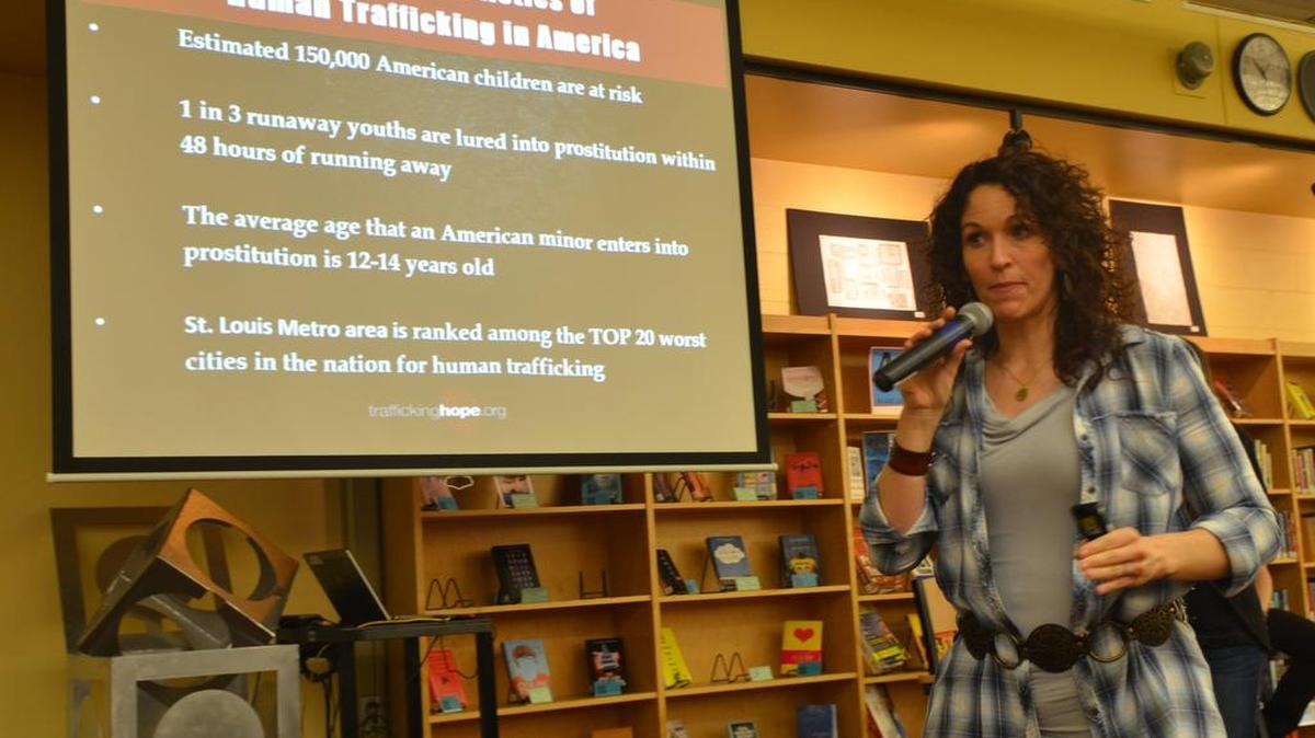 O’Fallon Township High School alumni Molly Venzke, author of “Caged No More,” speaks to students in the Instructional Media Center at the Smiley campus Friday about how to recognize, prevent and raise awareness for human (sex) trafficking.