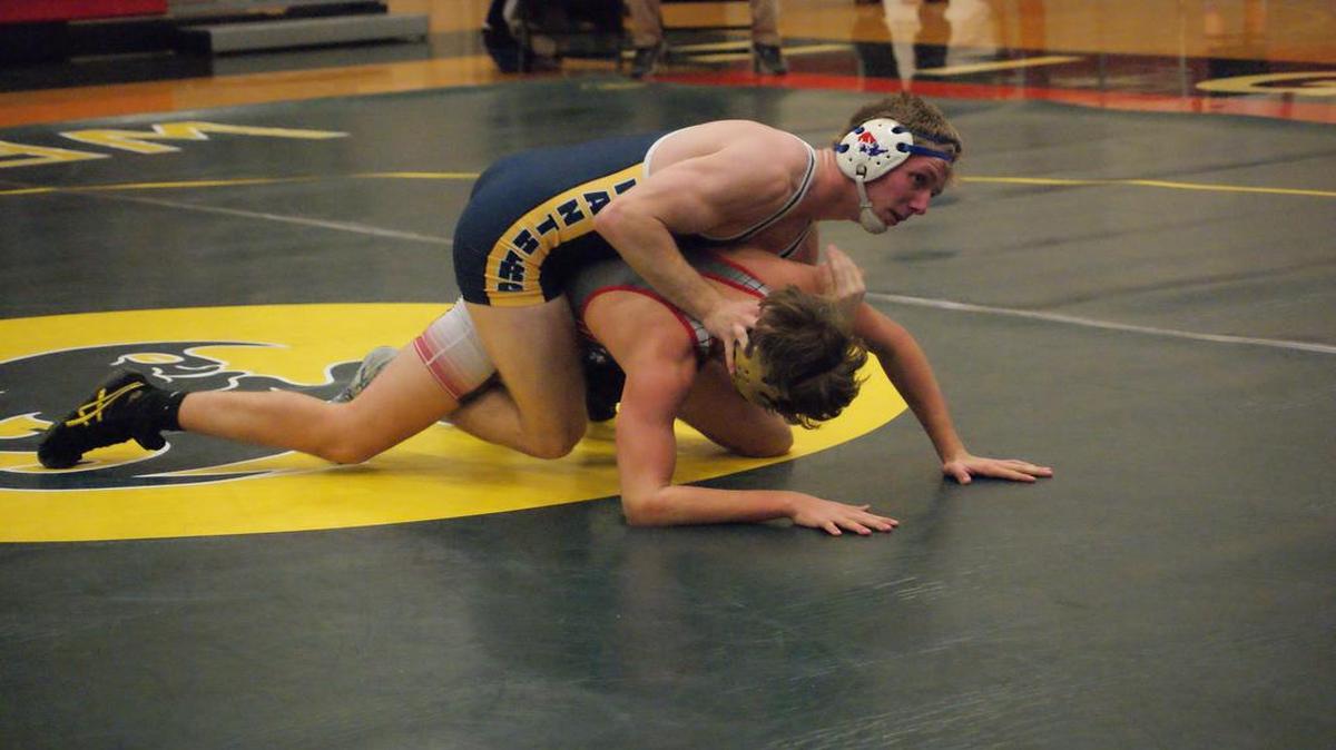 O’Fallon wrestler Jack Bond takes control of Highland’s Devin Wills en route to posting a 19-4 technical fall-victory in their 160-pound match in a triangular match Tuesday night at Highland High School. Bond also pinned Civic Memorial’s Gavin Witskin to help the Panthers dominate both the Eagles and Bulldogs.