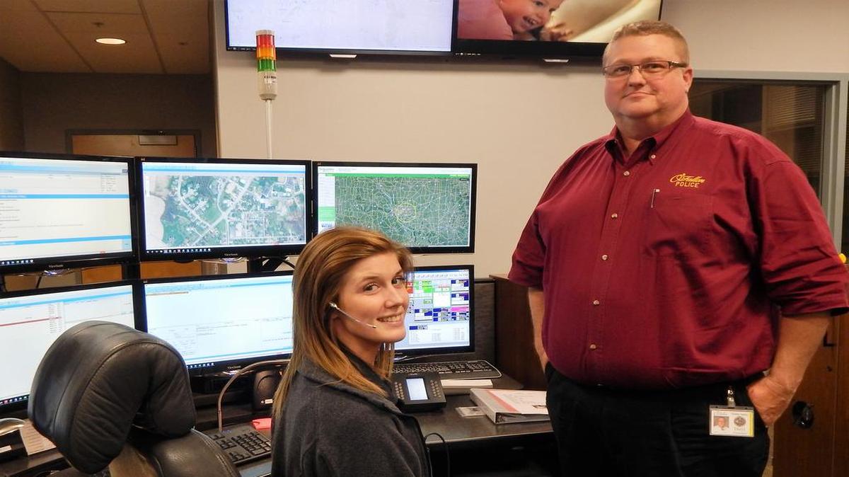 Daryl Ostendorf talks with telecommunicator Carmen Kuhl in the O’Fallon Telecommunications Center.