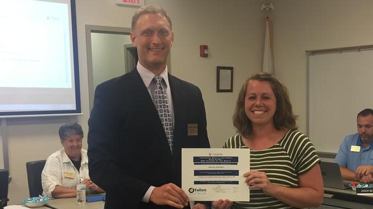 O’Fallon School District 90 Board of Education president John Wagnon presents Amanda Mellenthin, Carriel Science teacher, win the September Teacher of the Month award during the Tuesday, Sept. 19 board meeting.