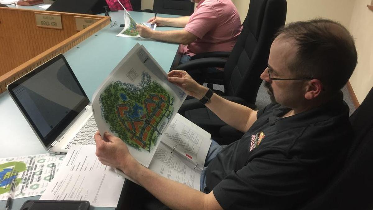 Shiloh Planning Commission member Howard Steffey looks on at a rendition of what will soon be a newcoming housing development to south of Memorial Hospital East in Shiloh during Monday, April 10 village Planning Commission meeting.