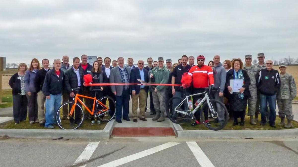 Dignitaries gather for a ribbon-cutting ceremony on the newly opened MetroBikeLink connection between the Shiloh Wingate Subdivision (north of Southwestern Illinois College) and Scott Air Force Base.