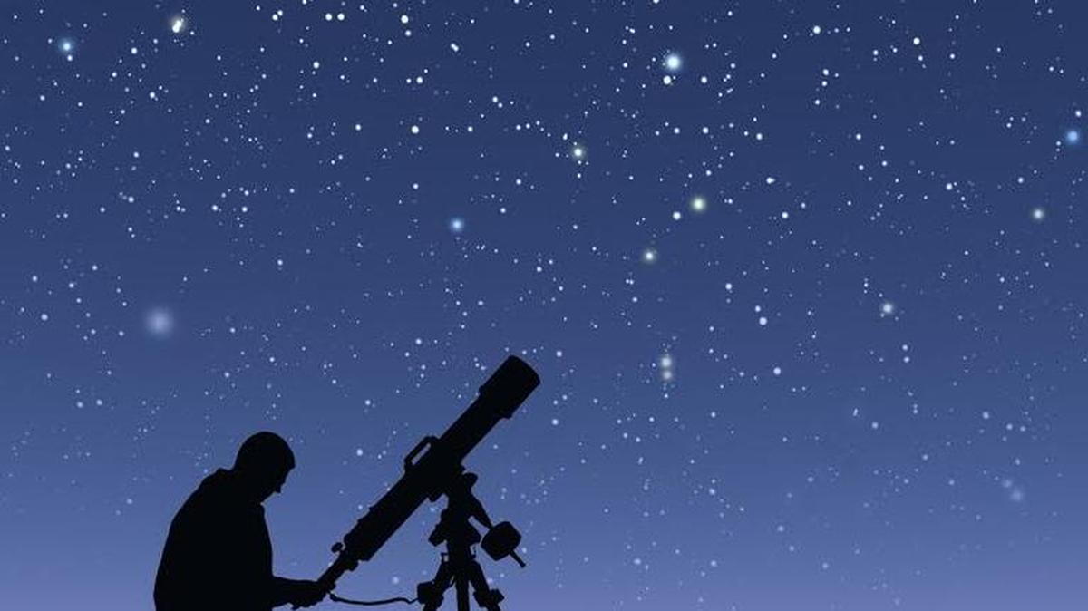 This image shows a stargazer with his telescope