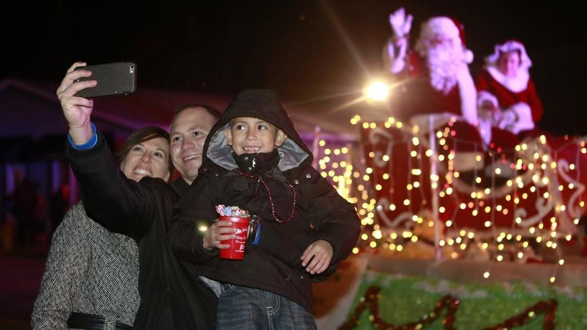 Corinne, Derek, and Carsen Clements of Swansea take a selfie with Santa Claus during the O’Fallon Illuminated Christmas Parade last year in O’Fallon.