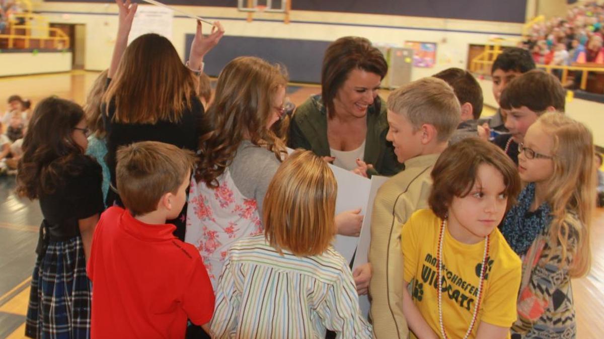 Kids gather around Marie Schaefer Elementary school nurse Lorilee Sebesto during Fri., Feb. 26 Leukemia & Lymphoma Society’s “Pennies For Patients” kick-off assembly.
