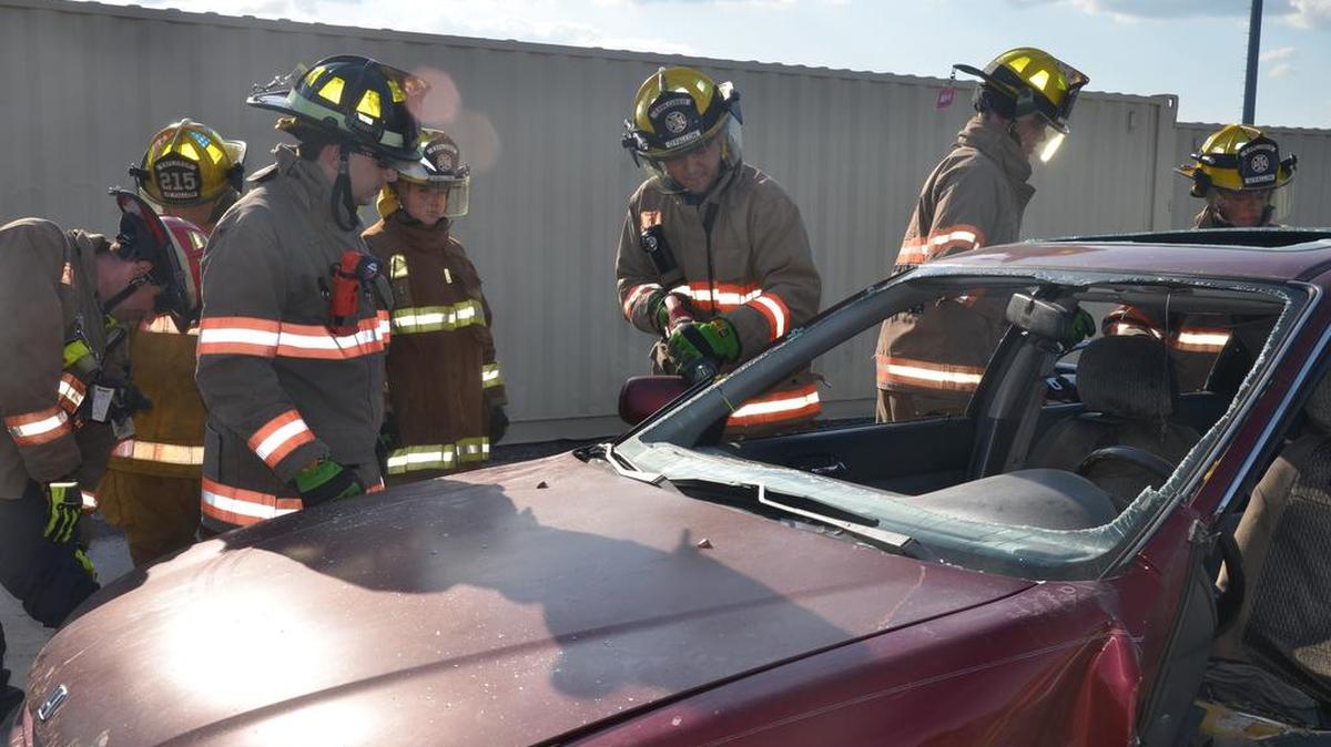 O’Fallon Firefighter Brandon Holt, along with Bryce Hartling, a fire explorer, work with other explorers to remove the roof of a car as part of an extrication demonstration with the ‘jaws of life,’ at the O’Fallon Emergency Medical Services (EMS) open house event at the new O’Fallon/EMS Headquarters, Fire House No. 4 at 1215 Taylor Road in O’Fallon last week.