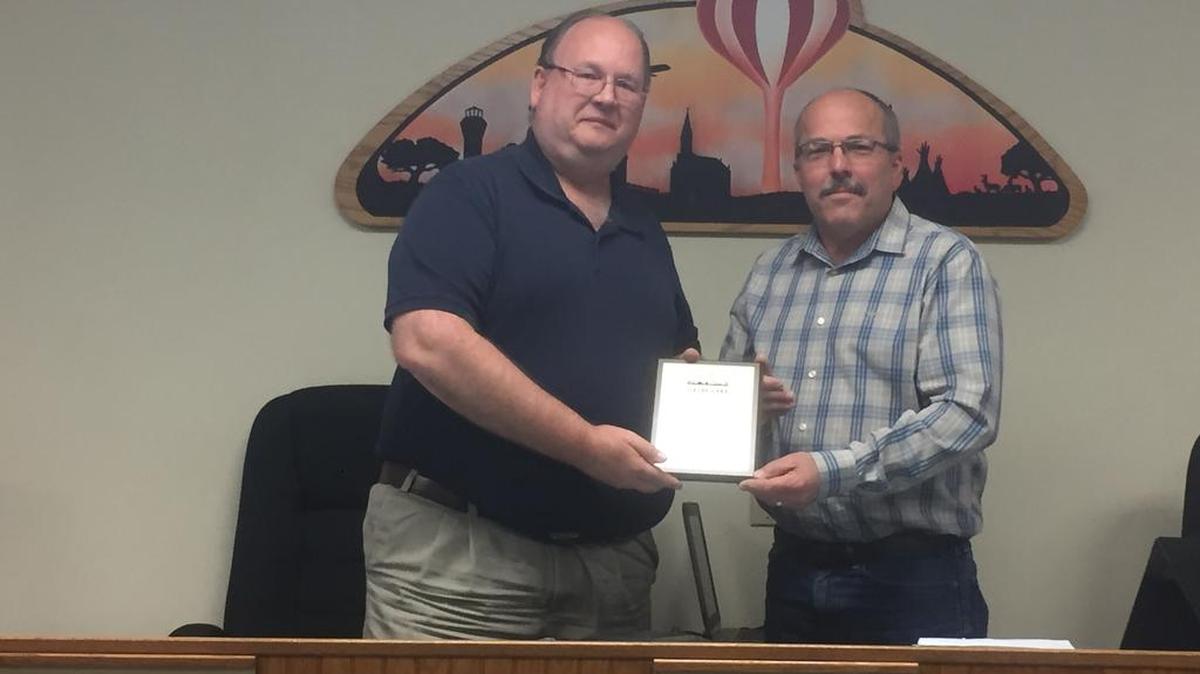 The village of Shiloh Board of Trustees said farewell to Mark Kurtz, trustee first elected in 2002, left, with Mayor Jim Vernier, right, presenting him with an honorary plaque to serve as a momento for his time on the board.