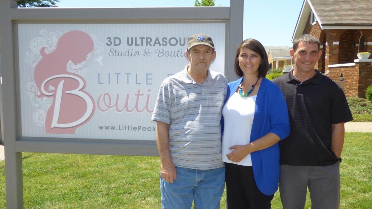Little Peek Boutique owner Melissa Thurlow with her husband, Jon Thurlow (on right), and father, Mark Jones.