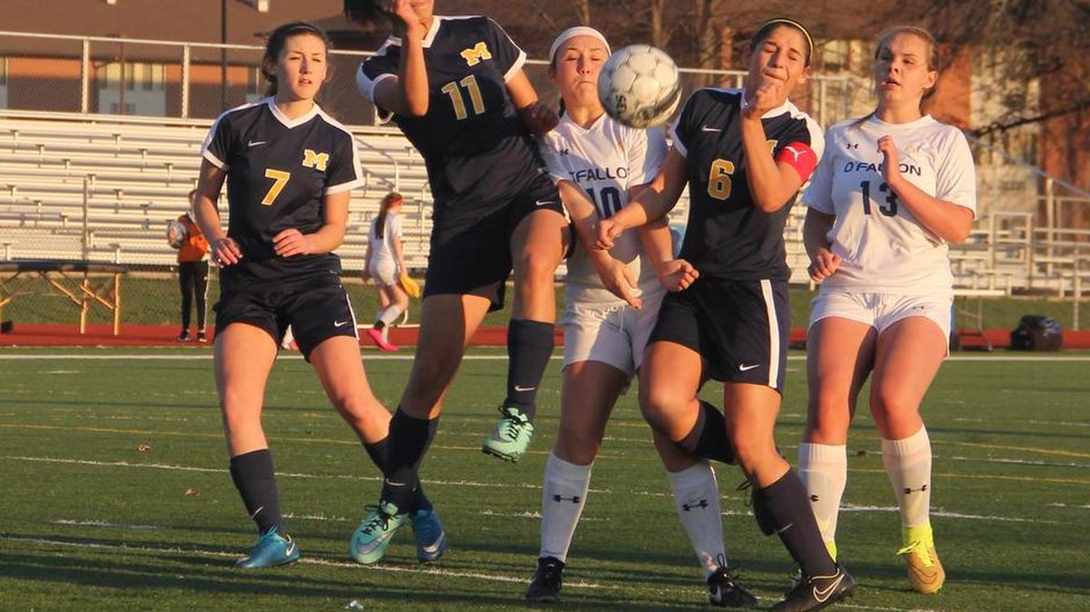 O’Fallon’s Andrea Wieman (10) and Gabby Goerke (13) battle Marion defenders for a loose ball during first half action Monday at O’Fallon Township High School.