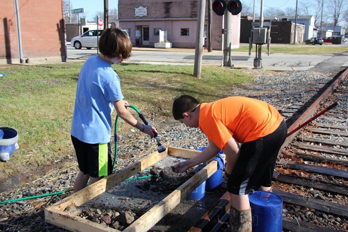 From left, Conner McGinnis and Tommy Fulford sifting through the O’Fallon History Museum Coal Mine Exhibit basement dirt for artifacts last year in January.
