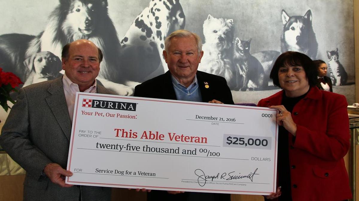 From left are Joe Sivewright, president of Purina; Phil Goodwin of O’Fallon; and Pam Largent, president of This Able Veteran at the check presentation.